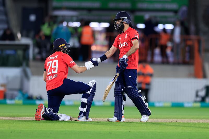 Moeen Ali of England congratulates teammate Dawid Malan on his half century. Getty 