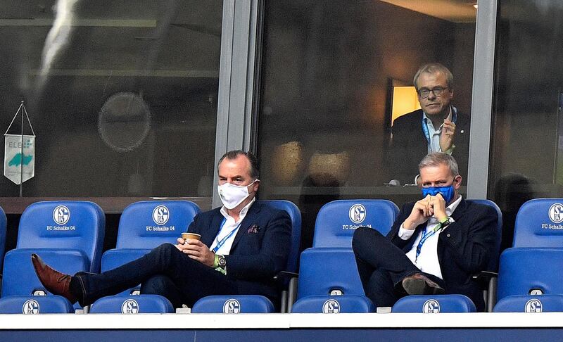 Schalke boss Clemens Toennies, left, watches from the stand with financial director Peter Peters, up, and supervisory board Jens Buchta. EPA