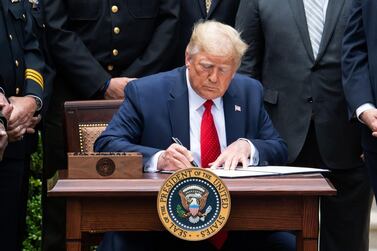 US President Donald Trump signs an Executive Order on Safe Policing for Safe Communities, in the Rose Garden of the White House in Washington, DC. AFP