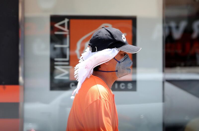 DUBAI, UNITED ARAB EMIRATES , June 11 – 2020 :- A person wearing protective face mask during the hot and humid weather in Al Satwa area in Dubai. (Pawan Singh / The National) For News/Standalone/Online/Stock