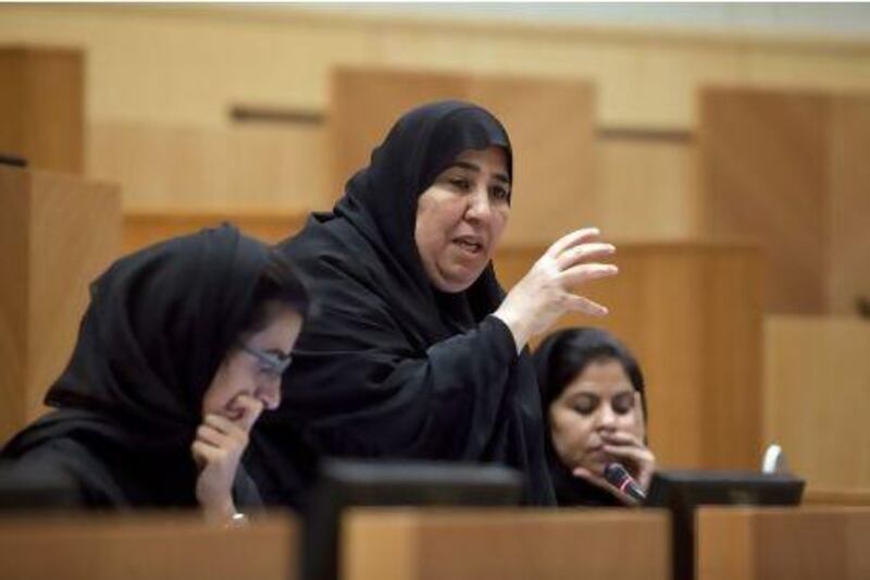 Fujairah FNC member Aisha Al Yammahi, also a school principal, makes her point on the need for teachers to be properly evaluated to the Minister of Education in yesterday's council session. Silvia Razgova / The National