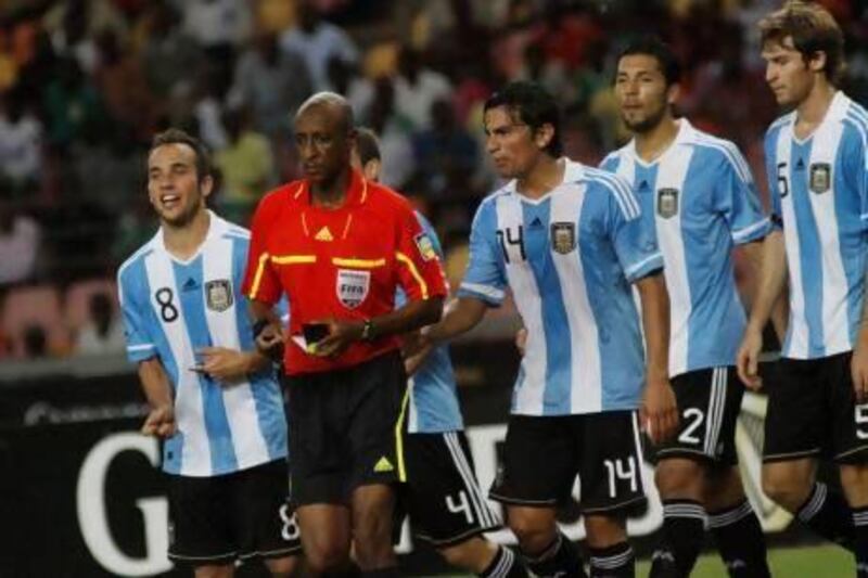 Ibrahim Chaibou, in red, a Fifa-registered referee, is surrounded by Argentina players after awarding a penalty against them during an international friendly against Nigeria in 2011. The official from Niger's questionable decisions prompted an investigation by Fifa and the Nigerian FA into the possibility the match had been fixed but no charges were ever made. Sunday Alamba / AP Photo