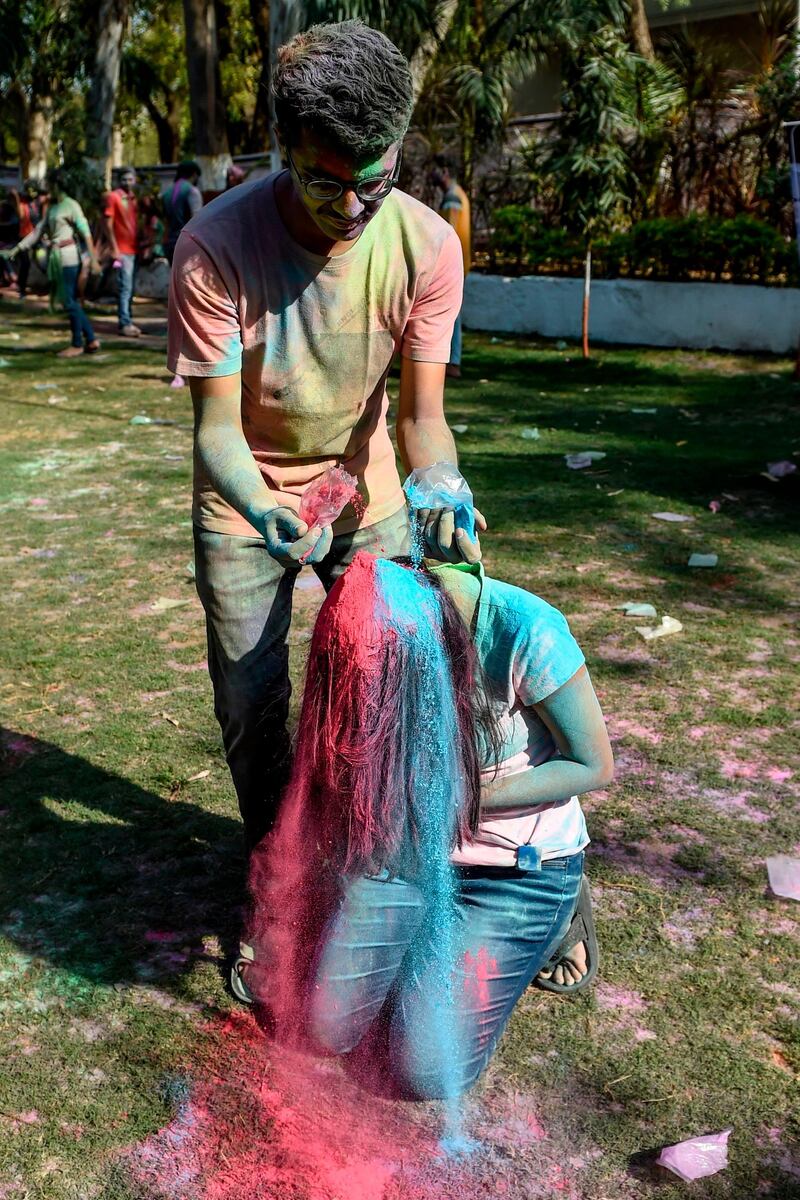 A student from Lalbhai Dalpatbhai (LD) College of Engineering puts coloured powder on a fellow as they celebrate 'Holi', the Hindu spring festival, with eco-friendly coloured powders in Ahmedabad on March 7, 2020. Holi, the popular Hindu spring festival of colours is observed in India and across countries at the end of the winter season on the last full moon of the lunar month. AFP