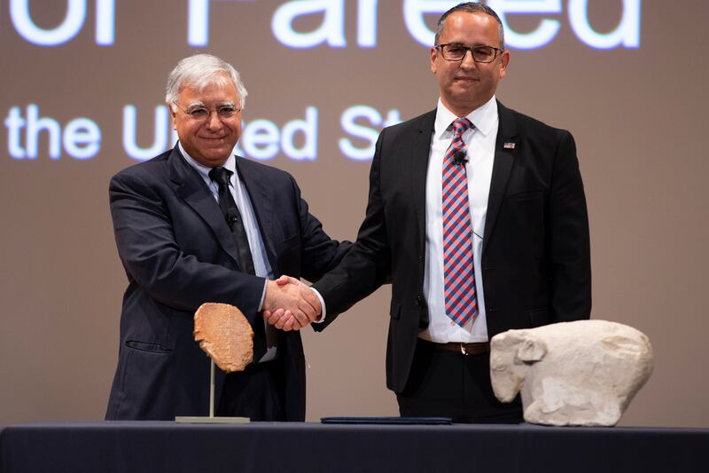 Fareed Yasseen, left, Iraq's ambassador to the United States, with Steven Francis, executive associate director of homeland security investigations at the US Department of Homeland Security. In front of them are the Gilgamesh tablet and Sumerian ram at a repatriation ceremony in Washington, DC. EPA