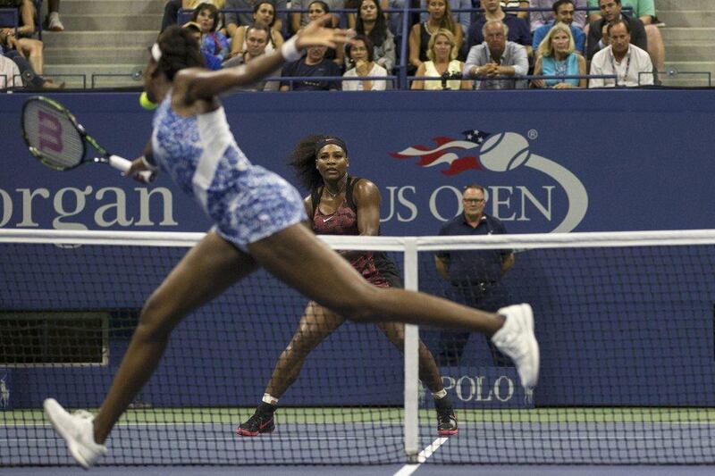 Venus Williams plays a shot to sister Serena during their quarter-final match at the US Open on Tuesday. Adrees Latif / Reuters