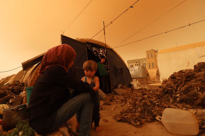 A family takes shelter in Zardana as the storm sweeps across Idlib province, north-western Syria.