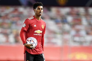 epa08782011 Marcus Rashford of Manchester United walks off with the match ball after scoring a hattrick in the UEFA Champions League group H match Manchester United vs RB Leipzig in Manchester, Britain 28 October 2020. Manchester United won 5-0. EPA/Peter Powell