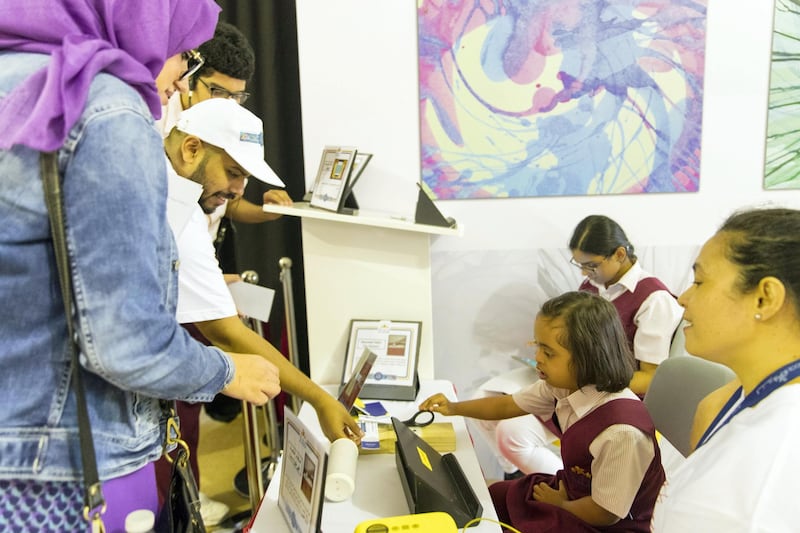 Dubai, United Arab Emirates, November 1, 2017:    A girl collects and cuts tickets during the Al Noor Assistive TechX experience at the Al Noor Training Centre for Children With Special Needs in the Al Barsha area of Dubai on November 1, 2017. The experience included a mock theatre and supermarket run by children with special needs showcasing how disabled people can still contribute to society in a meaningful way. Christopher Pike / The National

Reporter: Ramola Talwar
Section: News