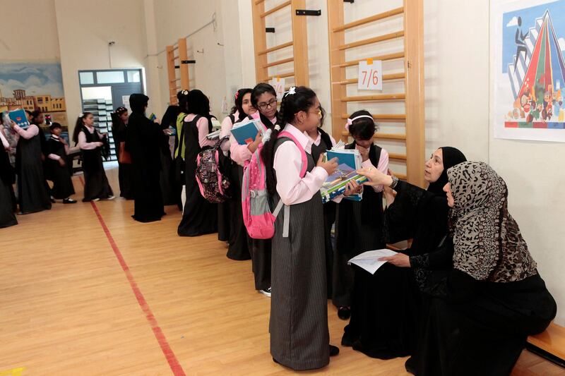 Dubai, United Arab Emirates - September 8, 2013.  Grade 7 students queue for the books they will use throughout the school year, during their first day of school in Nadd Al Hamar Primary School for Basic Education Cycle 2.  ( Jeffrey E Biteng / The National )  Editor's Note; Wafa I reports.  *** Local Caption ***  JB080913-Publicschool17.jpg