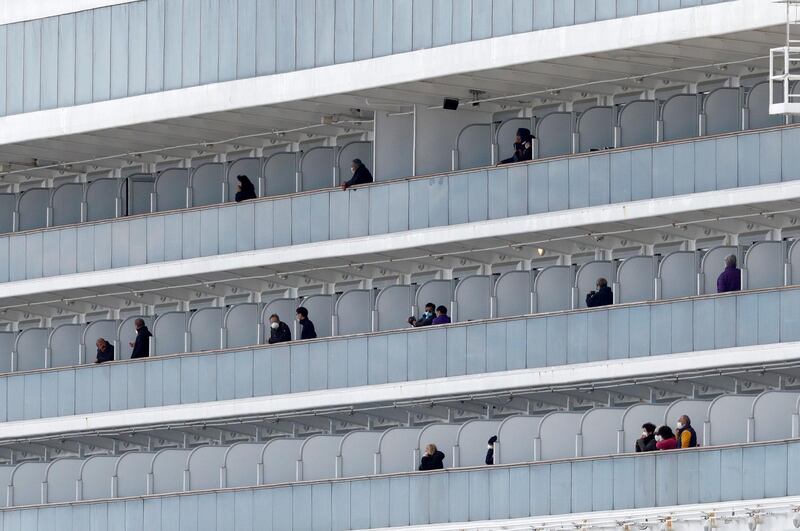 Passengers look out from the cruise ship Diamond Princess at Daikoku Pier Cruise Terminal in Yokohama, south of Tokyo. Reuters