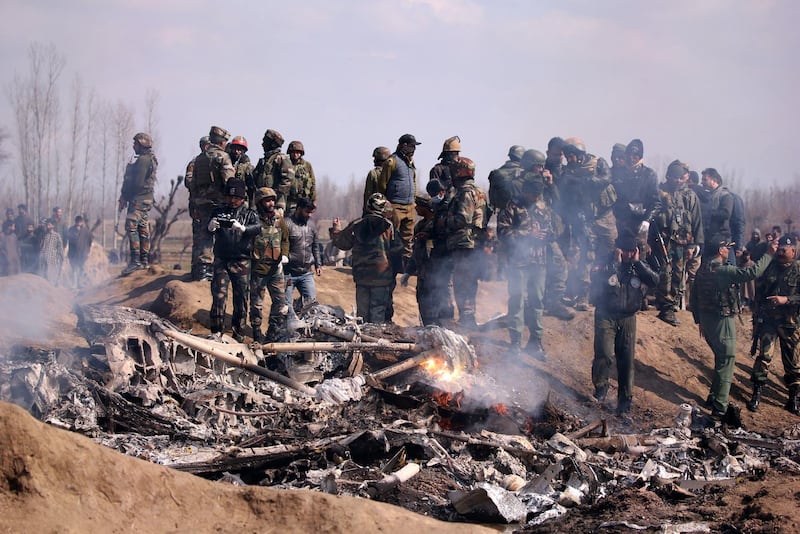 Indian soldiers stand next to the wreckage of the Indian Air Force's helicopter after it crashed in Budgam district in Kashmir. Reuters