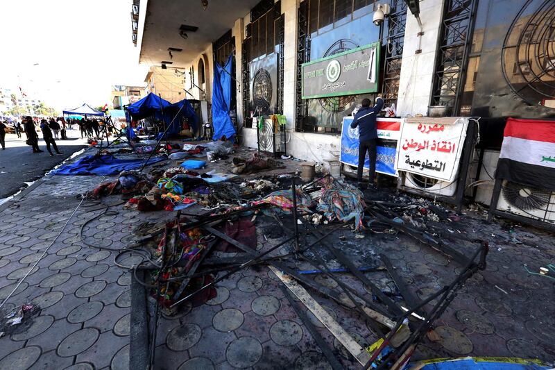 Iraqi protestesters inspect their tents which were burned out by anti-riot police forces in the previous day at the Al Tahrir square in central Baghdad, Iraq.  EPA