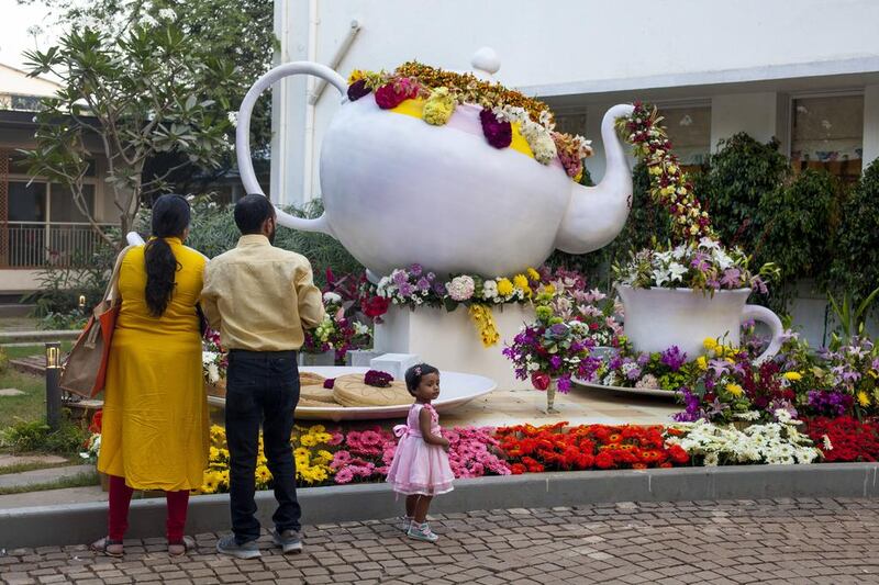 Clockwise from above, the Mrs Teapot from Beauty and The Beast garden; a pink dahlia flower in the Wishing Well Fairy Garden; the Rickshaw of Roses. Photos by Subhash Sharma for The National