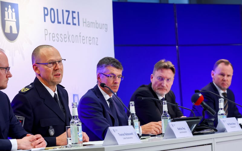 Hamburg police officers and politicians address journalists at a news conference. Reuters