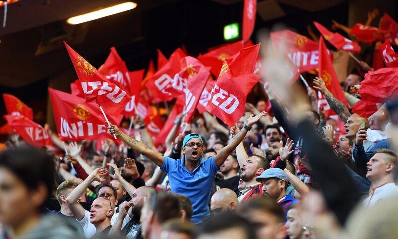 Manchester United fans wave flags on cheer on their team inside the Friends Arena. Georgi Licovski / EPA