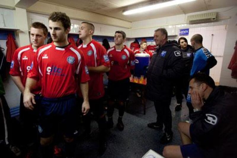 Hyde FC players get ready to step on to the pitch to play a game of football.