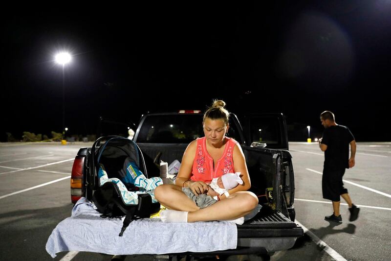 Lorrainda sits with her son in a parking lot. AP Photo