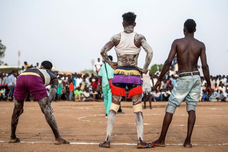 Wrestlers stand by the ring during a traditional Nuba wrestling competition in Sudan's capital Khartoum.