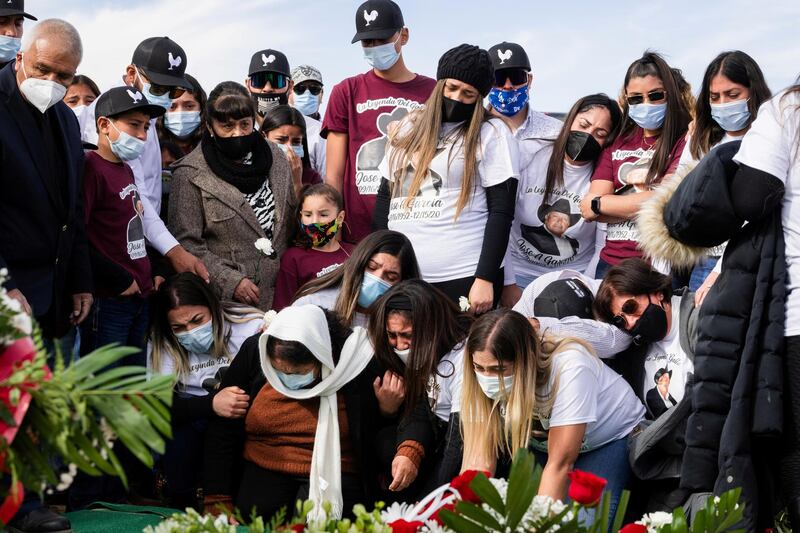 Family members and loved ones of Jose Garcia, who died from Covid-19, cry as he is laid to rest at the San Jose Cemetery in La Mesa, New Mexico, on December 22, 2020. Reuters