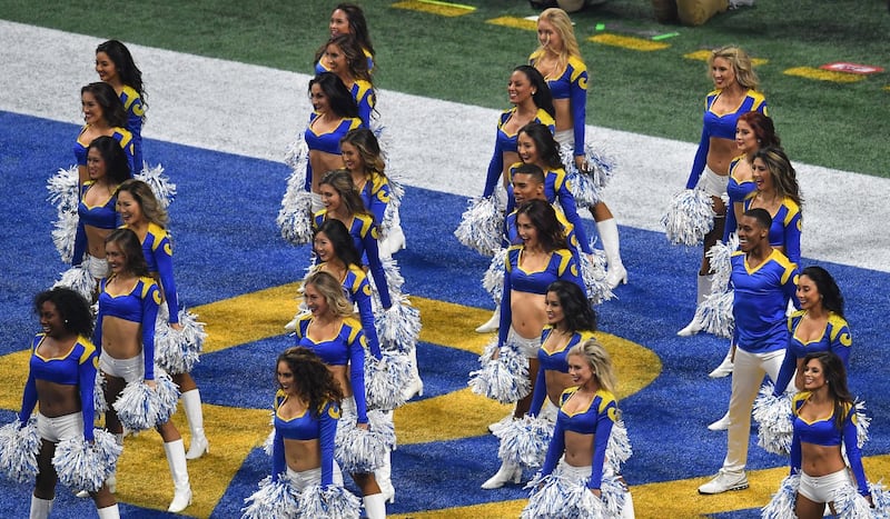 Rams cheerleader Quinton Peron (R) and Rams cheerleader Napoleon Jinnies (2nd row from R) perform with other cheerleaders during Super Bowl LIII between the New England Patriots and the Los Angeles Rams at Mercedes-Benz Stadium in Atlanta, Georgia, on February 3, 2019. (Photo by Angela Weiss / AFP)