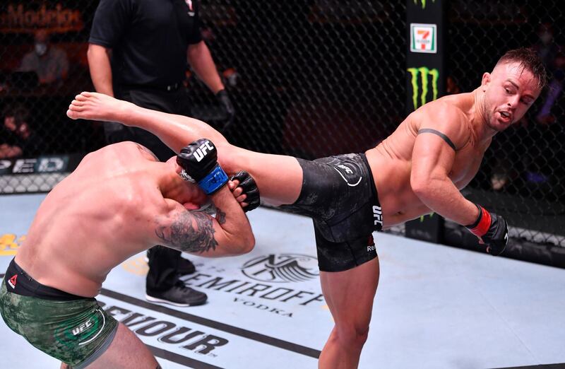 Cody Stamman kicks Brian Kelleher in their featherweight bout during UFC 250. Reuters