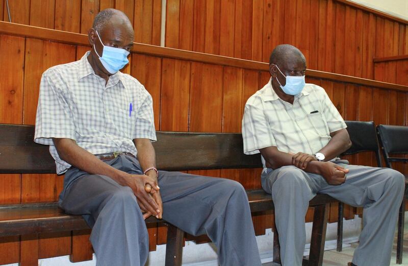 Kenyan police officers Naftali Chege (L) and John Pamba, accused of the killing Alexander Monson, a British citizen who was found dead in his prison cell in 2012, sit in the dock during the ruling of their case at the high court in Mombasa, Kenya March 22, 2021. REUTERS/Joseph Okanga