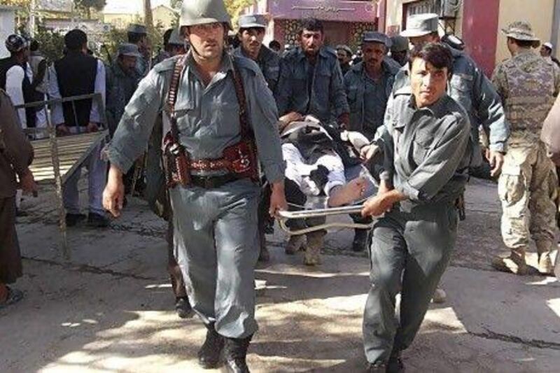 Afghan policemen carry the body of a civilian after a bomb blast in Faryb province killed at least 42 people at a mosque in Afghanistan's relatively peaceful northern region, police officials said.