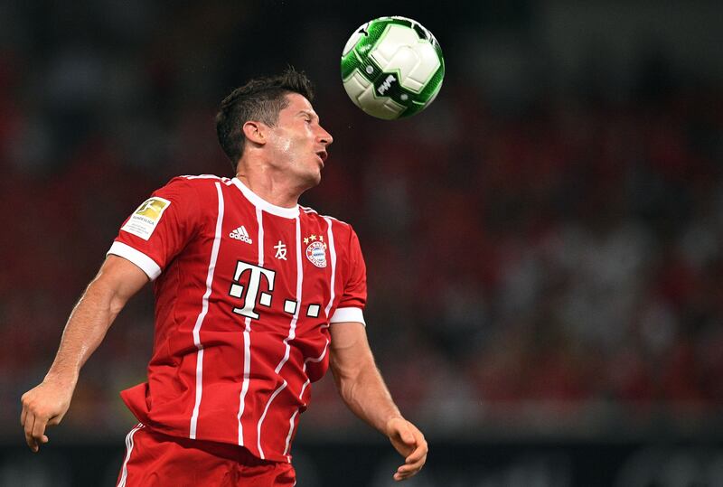 Bayern Munich's forward Robert Lewandowski leaps for the ball. Johannes Eisele / AFP