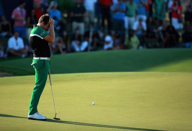 Tyrrell Hatton of England reacts to a missed putt on the 18th green. Warren Little / Getty Images