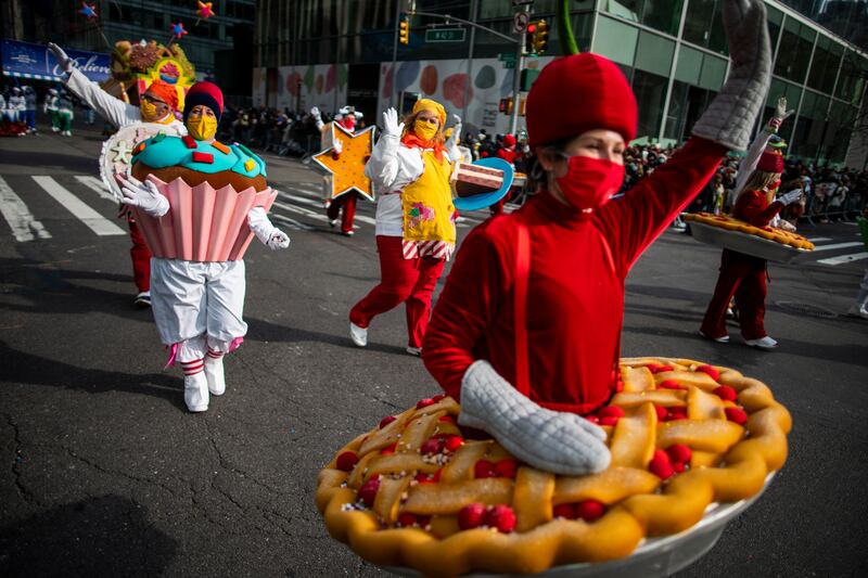 People in costumes walk down Sixth Avenue during the Macy's Thanksgiving Day Parade. AP