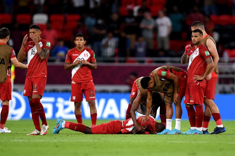Dejected Peru players support each other after being defeated by Australia. Getty Images