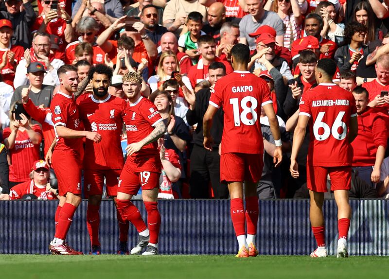 Liverpool's Mohamed Salah celebrates scoring their first goal with Harvey Elliott and Alexis Mac Allister. Reuters