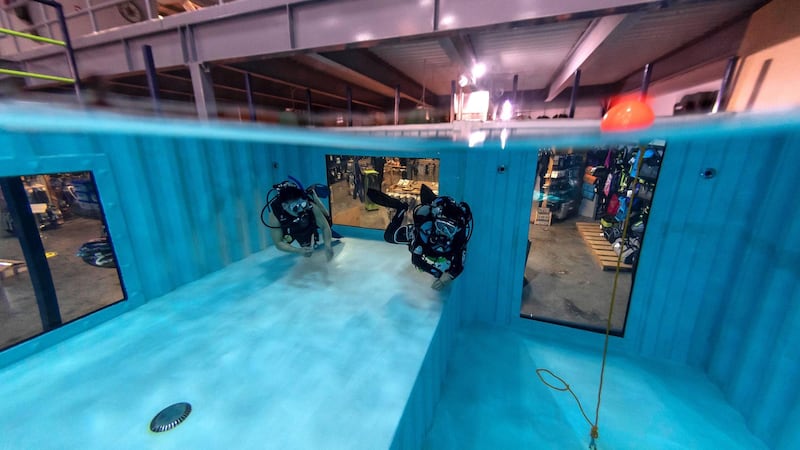 DUBAI, UNITED ARAB EMIRATES. 07 MARCH 2021.   Michela Colella, Dive Instructor, conducts a training session with a learner diver in the newly opened indoor pool at the Dive Garage facility in Al Quoz 4. The pool is constructed out of shipping containers and hols a 100 000 liters of fresh water, making it one of a kind in the Middle East. (Photo: Antonie Robertson/The National) Journalist: Janice Rodriques. Section: National.