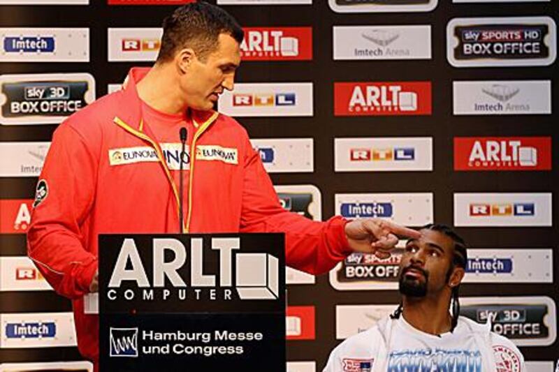 Wladimir Klitschko, left, holds the stage in a press conference in Hamburg to get his point across with David Haye looking on.