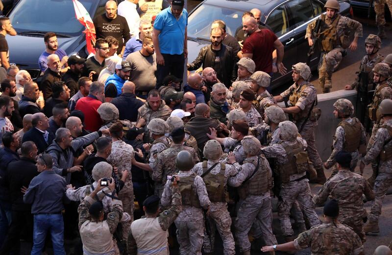Backers of the Free Patriotic Movement founded by the Lebanese president scaffle with soldiers during a rally in his support on a road leading to the presidential palace in Baabda near the capital Beirut. AFP