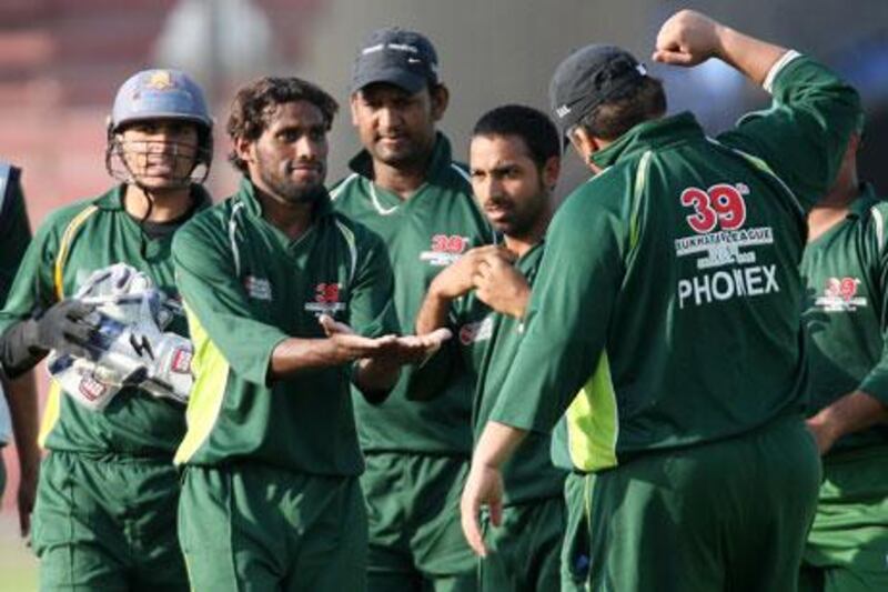 Mohsin Anwer, centre, of Phoenix Medicine celebrates after taking the wicket of Arfan Haider in the Bukhatir cricket final between Phoenix Medicine vs Abu Dhabi Gymkhana at Sharjah Cricket Stadium in Sharjah. He took three wickets in this match.