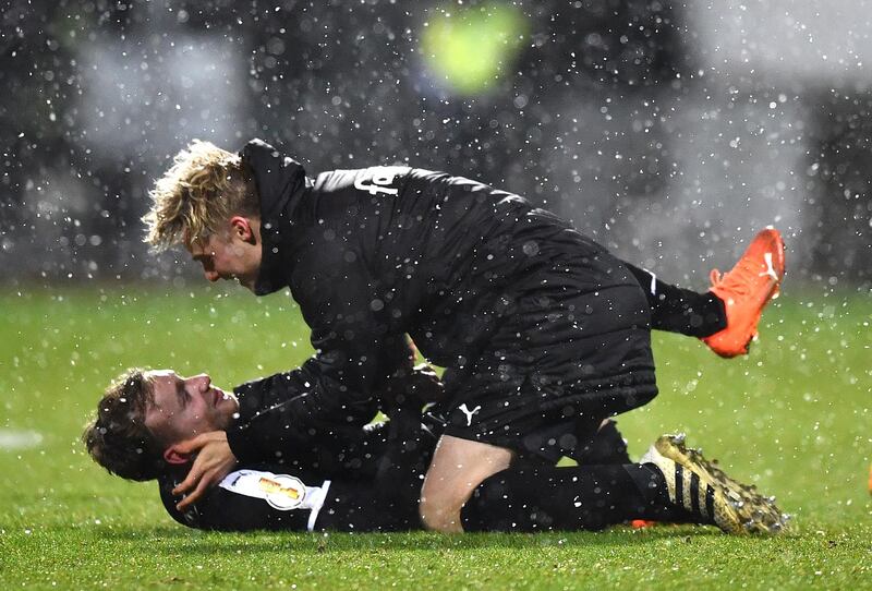 Holstein Kiel's Jannik Dehm celebrates with teammate after their shock DFB Cup win over Bayern. Getty
