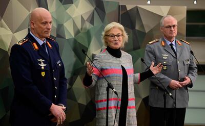 German Defence Minister Christine Lambrecht, centre, speaks at a press conference in Berlin. AFP