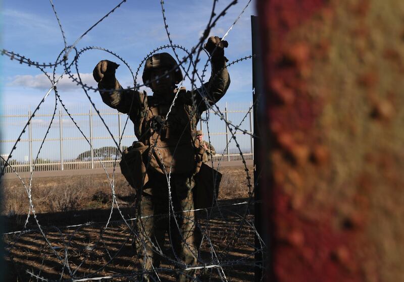 US Marines install razor wire along the US-Mexico border fence, as seen from Tijuana, Mexico. Getty Images