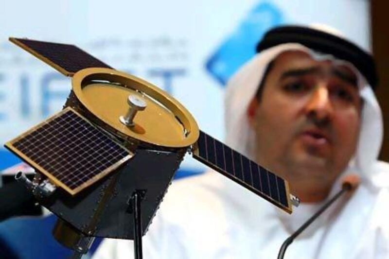 DUBAI. 4th August. 2009. DUBAISAT-1 LAUNCH. His Excellency Ahmed Al Mansoori, Director General of EIAST( Emirates Institute for Advanced Science and Technology) with a model of the DubaiSat-1 satellite at a press conference in Dubai yesterday(tues) to announce the successful launch of the satelite. Stephen Lock / The National . *** Local Caption *** SL-satelite-001.jpg