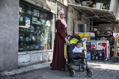 Sondos Shaaban, a 28-year-old nurse from Ramla as she runs errands with her one year old son .For Ms Shaaban, boycotting the elections Ð as many Arabs disaffected with their parties and Israeli politics have chosen to do Ð isnÕt an option. Photo by Heidi Levine for The National.
