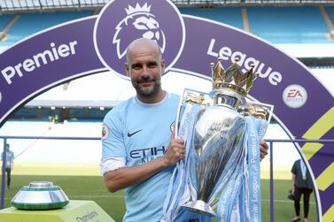 File photo dated 06-05-2018 of Manchester City manager Pep Guardiola celebrates with the Premier League trophy. Issue date: Wednesday May 12, 2021. PA Photo. Manchester City manager Pep Guardiola hailed the most remarkable of Premier League title victories in a relentless campaign after his side were crowned champions of England once again following defeat for Manchester United by Leicester. See PA story SOCCER Man City. Photo credit should read Martin Rickett/PA Wire.