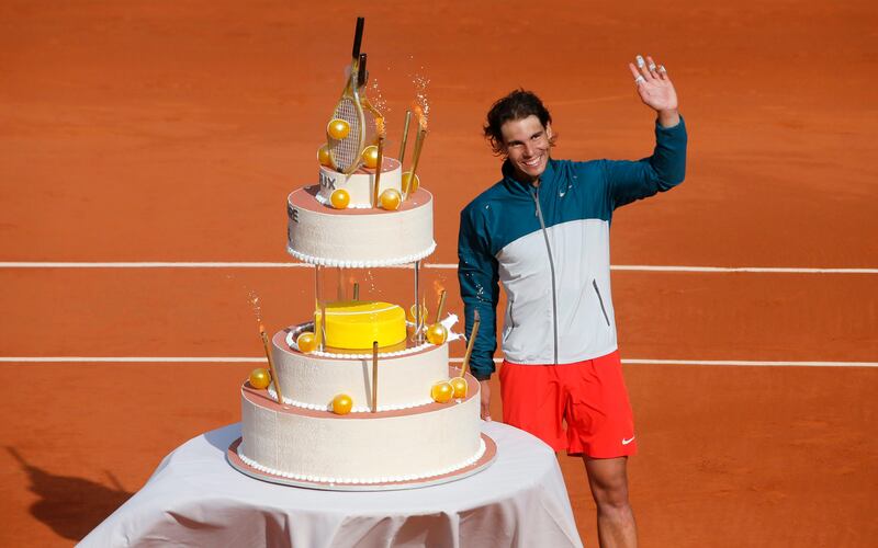 Defending champion Spain's Rafael Nadal waves at his a bithday cake on center court after defeating Japan's Kei Nishikori during their fourth round match of the French Open tennis tournament at the Roland Garros stadium Monday, June 3, 2013 in Paris. Nadal, who turned 27, won 6-4, 6-1, 6-3. (AP Photo/Michel Spingler) *** Local Caption ***  France Tennis French Open.JPEG-035c6.jpg