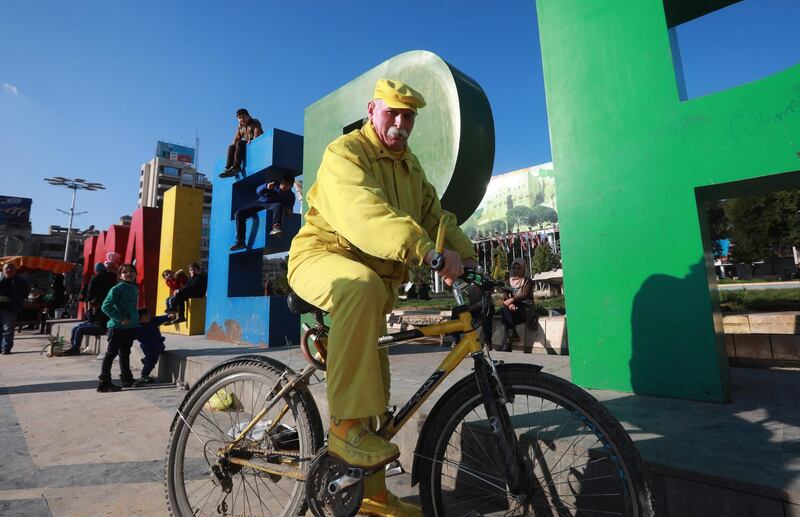 Abu Zakkour, Aleppo's so-called 'yellow man' rides his bicycle in the central Saadallah al-Jabiri square in the northern Syrian city. All photos by AFP
