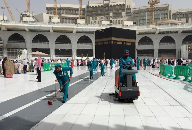 Workers clean the Grand Mosque, during the minor pilgrimage, known as Umrah, in the Muslim holy city of Mecca, Saudi Arabia. At Islam’s holiest site in Mecca, restrictions put in place by Saudi Arabia to halt the spread of the new coronavirus saw far smaller crowds than usual on Monday. AP Photo