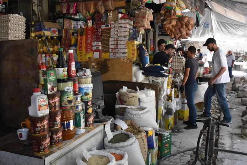 Syrians shop at a market in Damascus, Syria. EPA