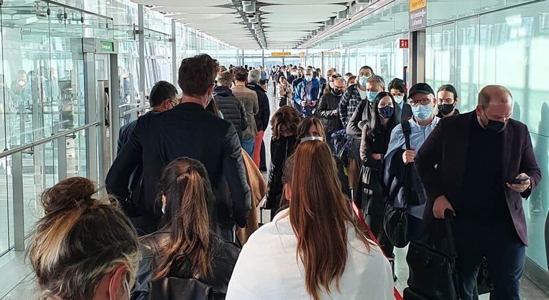 Passengers queue for the Arrival Hall at London Heathrow Airport's Terminal 5, due to a problem with the self-service passport gates.