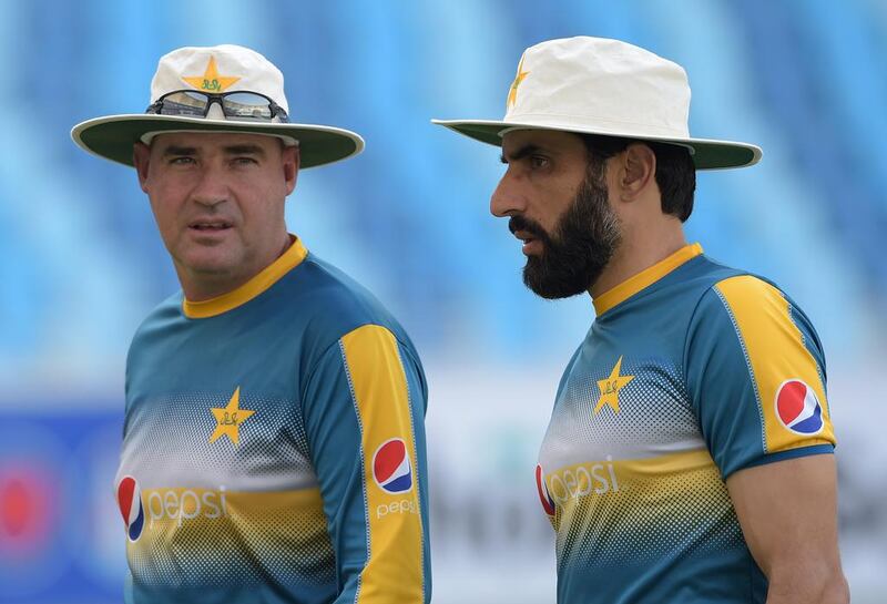 Pakistani cricket captain Misbah-ul-Haq and head coach Mickey Arthur arrive at the Dubai International Cricket Stadium in the Gulf Emirate for a practice session on October 12, 2016. Aamir Qureshi / AFP