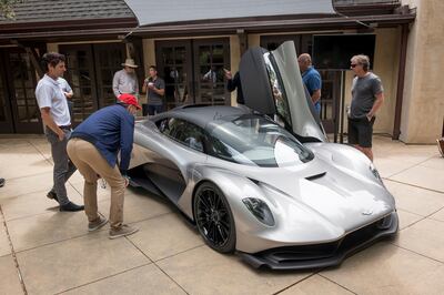 Attendees view the Aston Martin Lagonda Ltd. Valhalla supercar on display during an event at the 2019 Pebble Beach Concours d'Elegance in Carmel, California, U.S., on Saturday, Aug. 17, 2019. Aston Martin debuted its hypercar Valhalla, a road legal vehicle inspired by F1 technology and engineering, including pronounced front keel and large rear diffuser. Photographer: David Paul Morris/Bloomberg