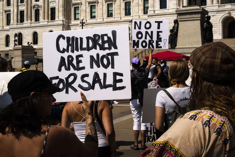ST PAUL, MN - AUGUST 22: People march during a "Save the Children" rally outside the Capitol building on August 22, 2020 in St Paul, Minnesota. Hundreds of rallies around the country, meant to decry human trafficking and pedophilia, are scheduled for today, some of which have been linked to social media accounts promoting the QAnon conspiracy.   Stephen Maturen/Getty Images/AFP
== FOR NEWSPAPERS, INTERNET, TELCOS & TELEVISION USE ONLY ==
